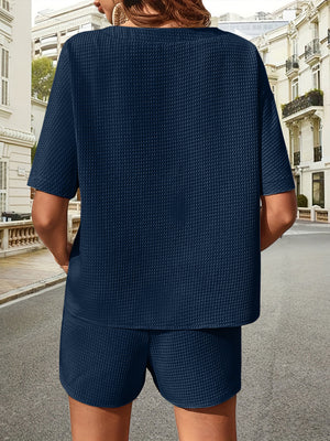 Dark blue waffle knit drawstring co-ord set with short sleeves and shorts.