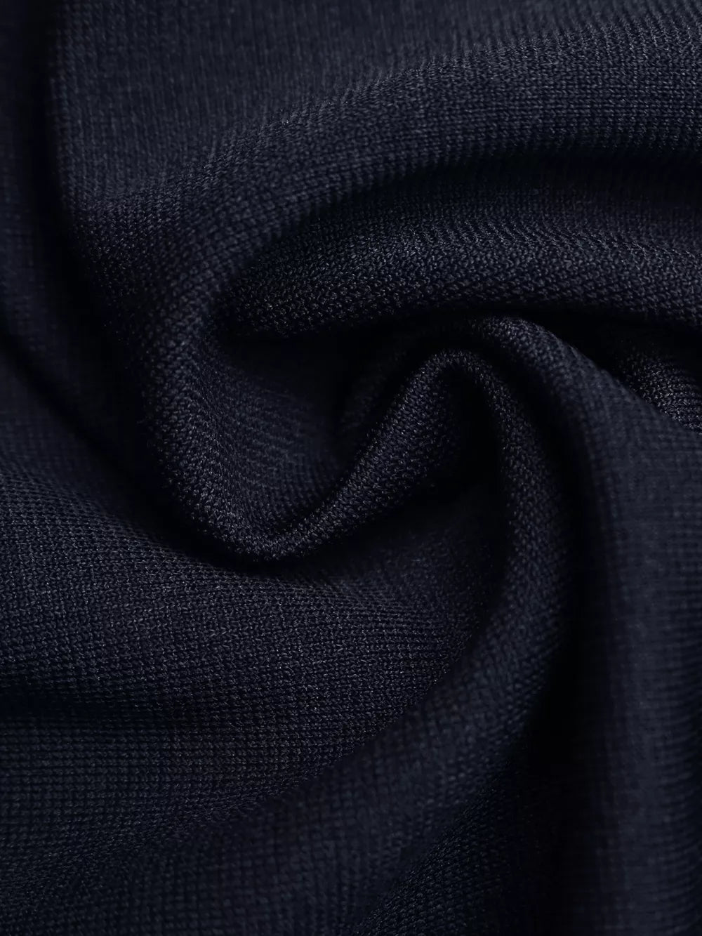 Navy knit vest fabric detail with subtle texture.