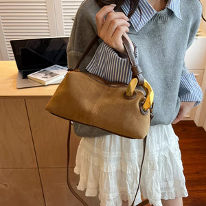 Taupe suede crossbody bag with gold hardware and brown leather trim