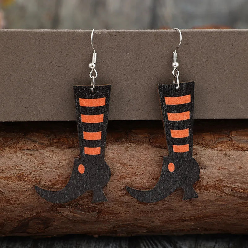 Black witch boot silhouette drop earrings with orange stripes and hook backs.