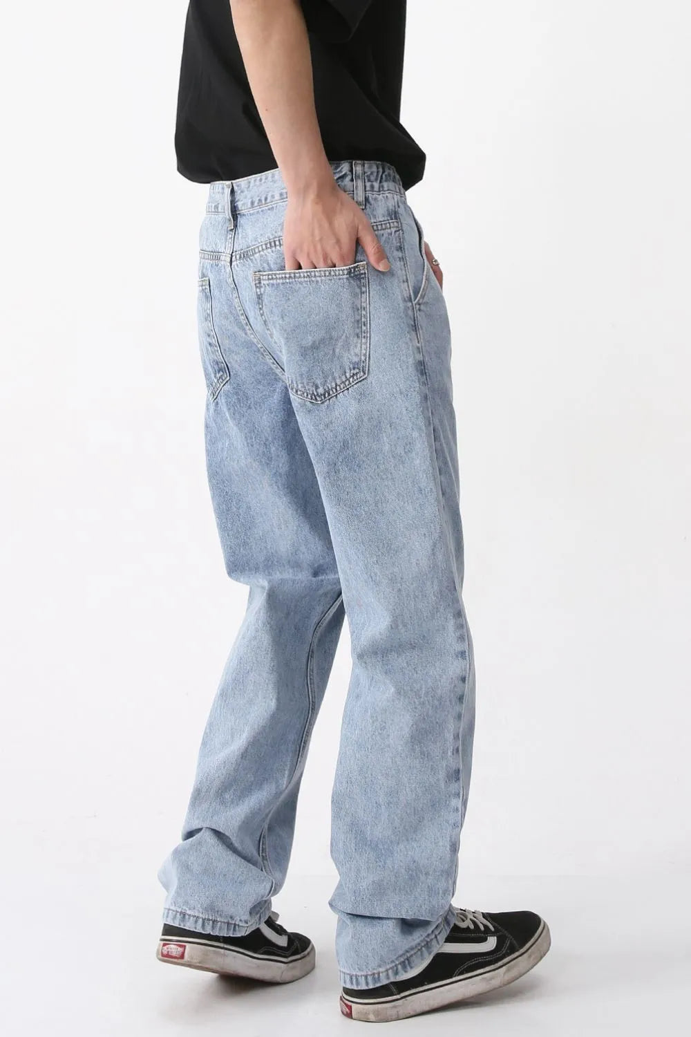 Pleated denim wide-leg trousers in medium wash, featuring a relaxed fit and casual styling.
