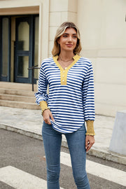 Striped long sleeve blouse with mustard neckline and cuffs, V-neck with buttons.