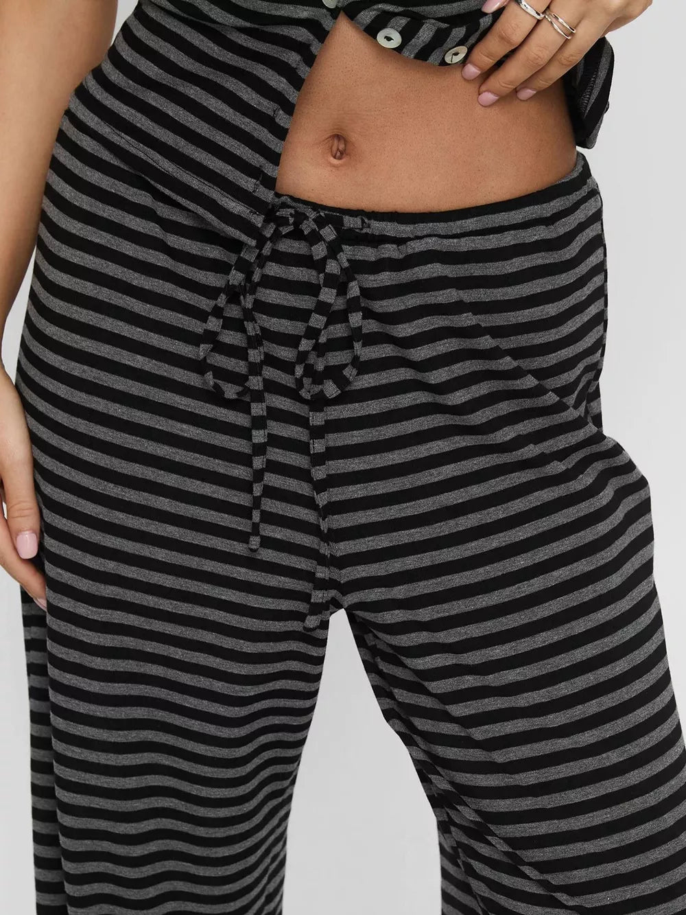 Dark gray and black striped cropped button-down and wide-leg pants set with drawstring waist.