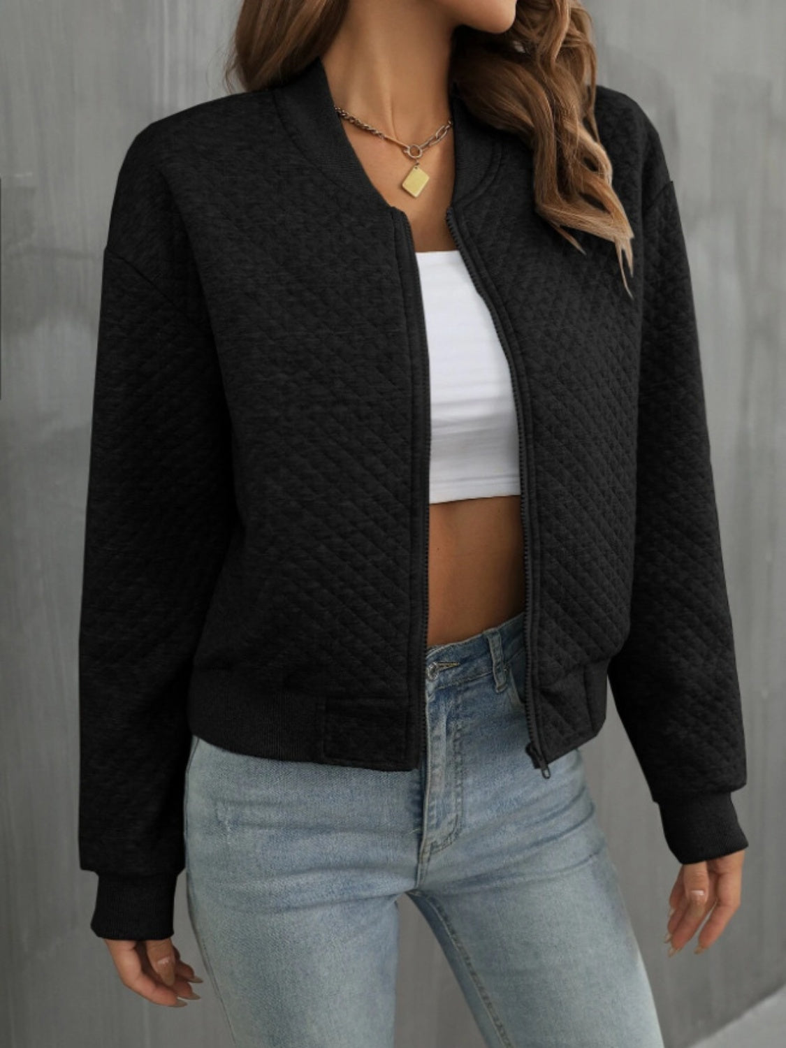 Black diamond quilted bomber jacket with a zip front and ribbed cuffs and hem.