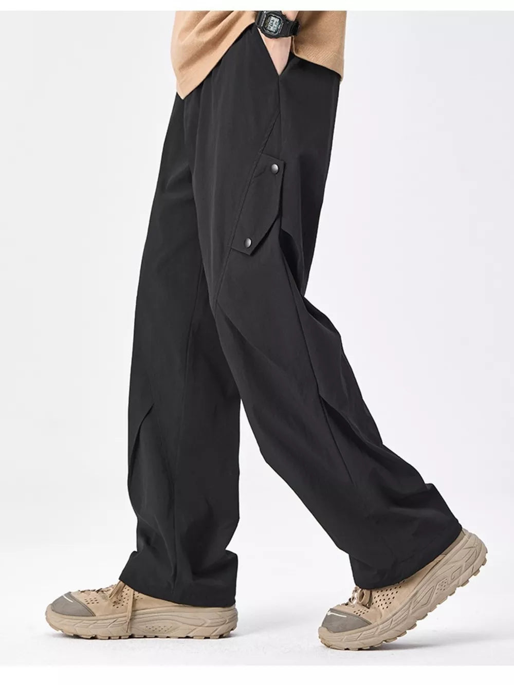 Black relaxed fit cargo sweatpants with snap-button pockets and a wide leg.