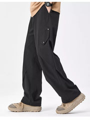 Black relaxed fit cargo sweatpants with snap-button pockets and a wide leg.