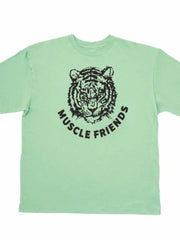 Oversized graphic tee in Gum Leaf green with a black tiger face and Muscle Friends text.