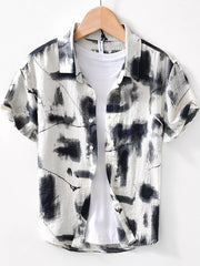 Men's white short sleeve shirt with abstract black print, button-down collar, casual style.