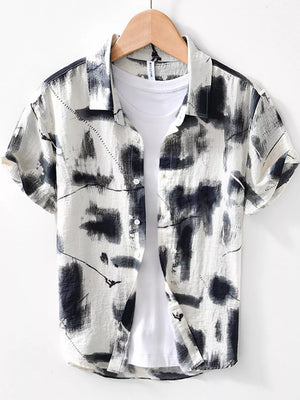 Men's white short sleeve shirt with abstract black print, button-down collar, casual style.