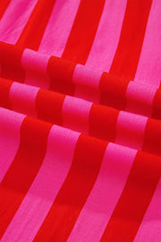Vibrant puff sleeve shirt in bold red and pink stripes, cotton blend fabric.