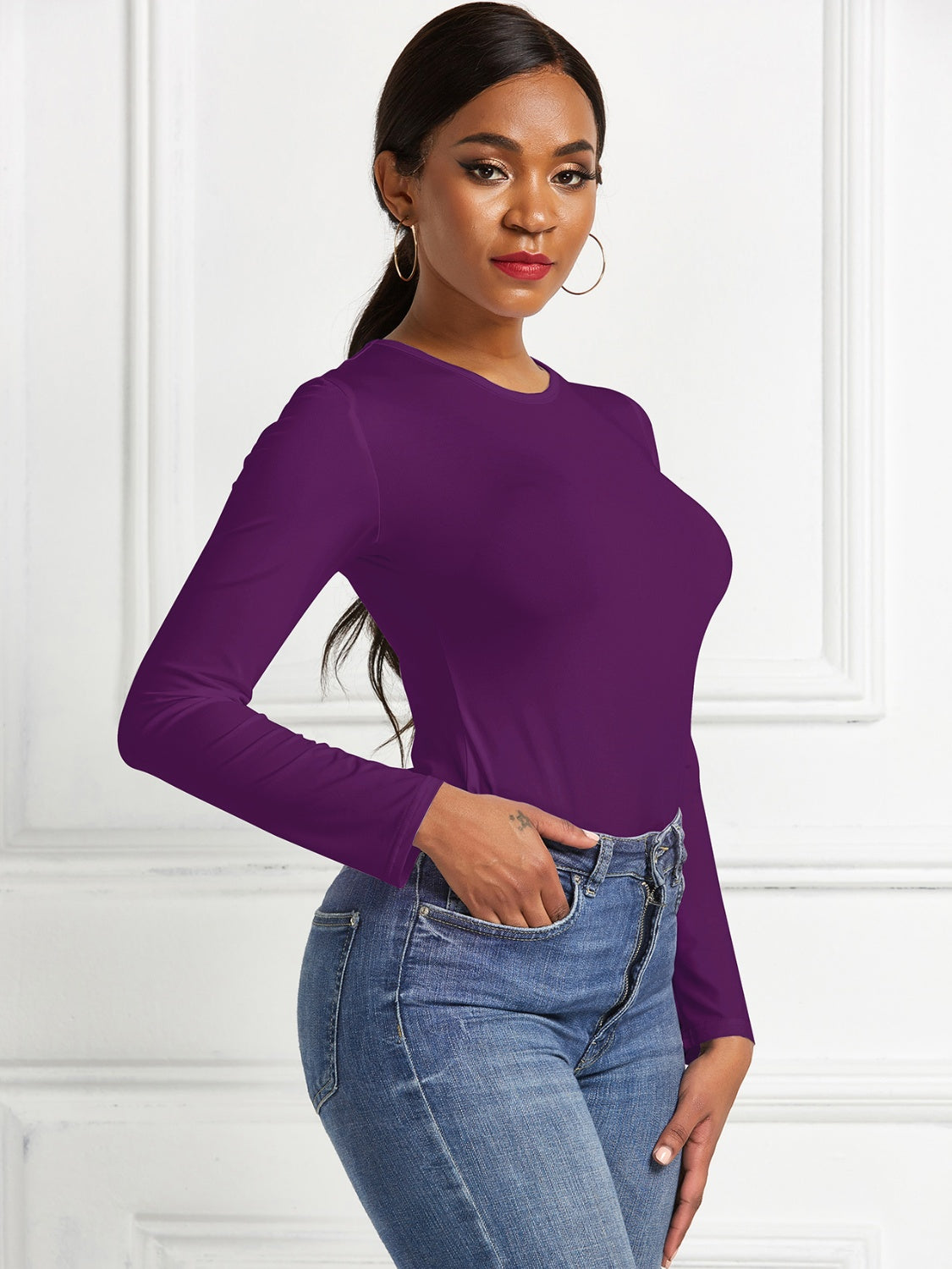 Deep Purple long sleeve ribbed jersey bodysuit with a crew neck.