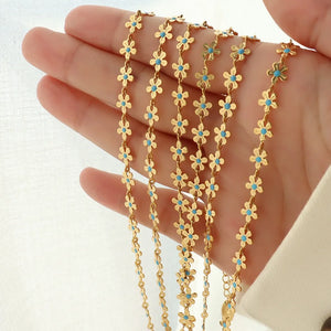 Gold daisy chain enamel petal necklace with blue centers