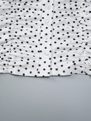 White polka dot t-shirt with ruched sides and button front detail.