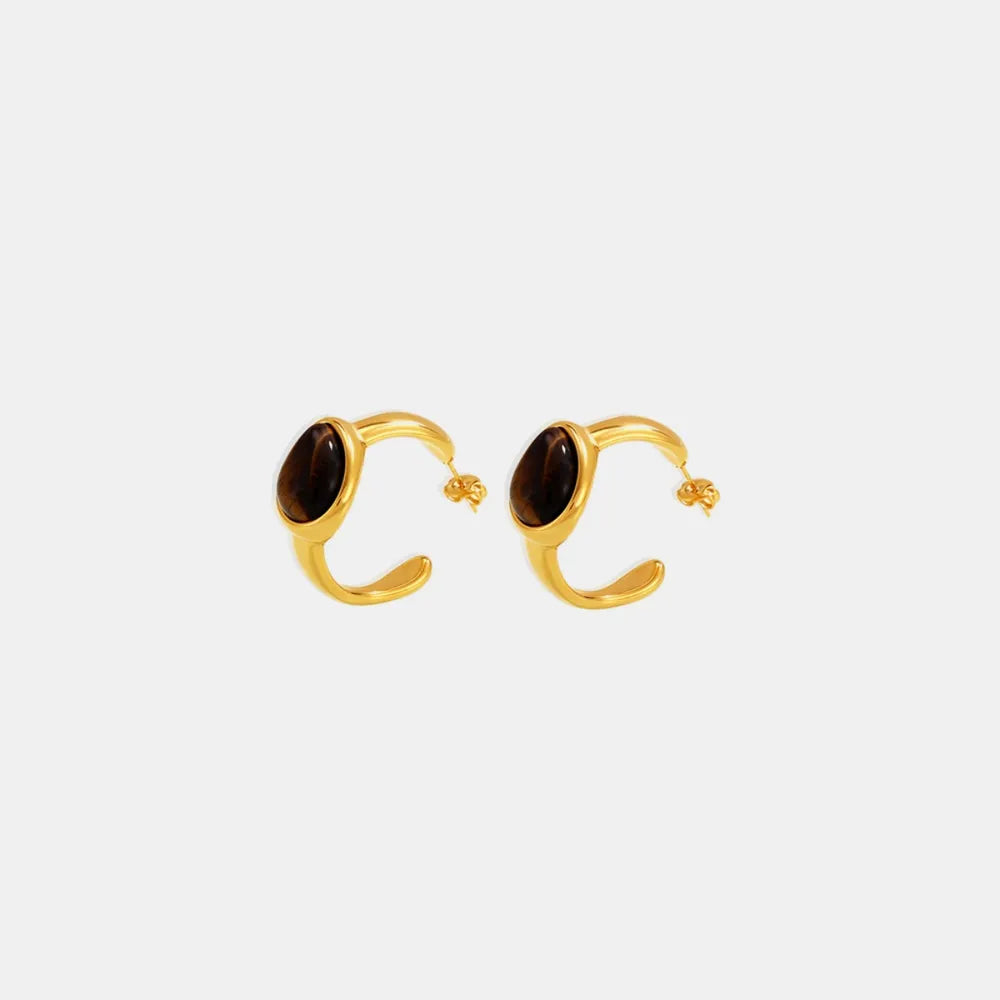 Gold sculptural hoop earrings with oval tiger's eye stones