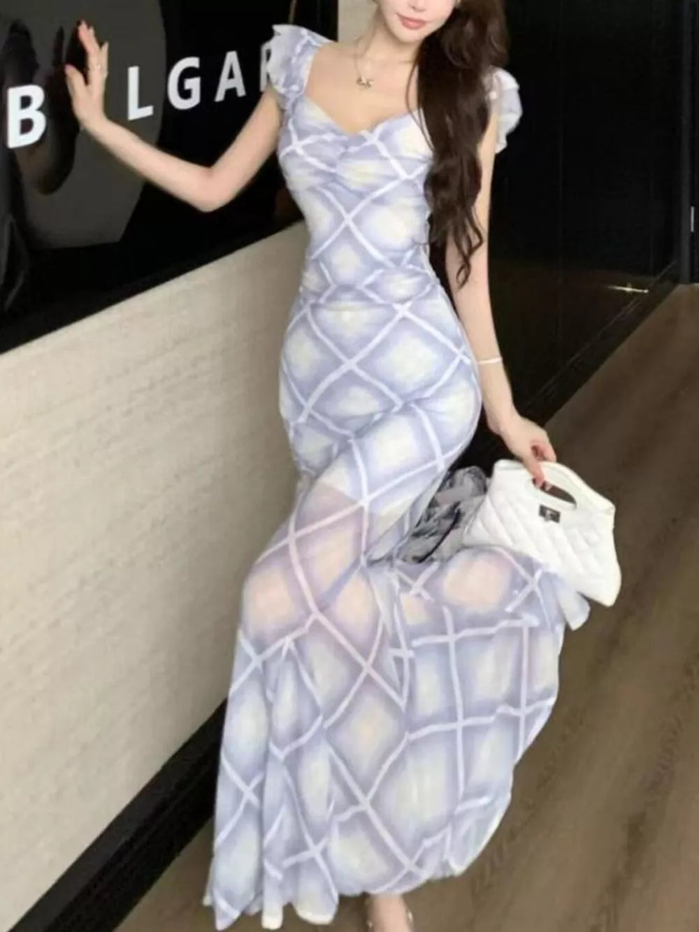 Ruched plaid bodycon maxi dress in blue with sweetheart neckline and short flutter sleeves.