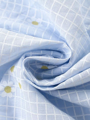 Baby dress with blue gingham and daisy print, cotton blend fabric detail