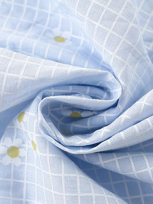 Baby dress with blue gingham and daisy print, cotton blend fabric detail