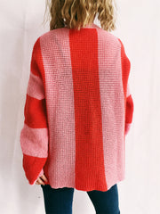 Vertical stripe waffle knit sweater in red and pink acrylic, crew neck, long sleeves.