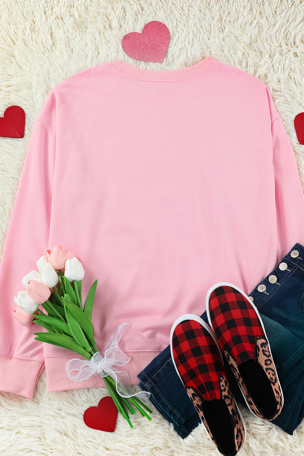 Blush pink drop shoulder sweatshirt with crewneck and cuffed sleeves.