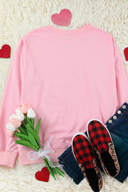 Blush pink drop shoulder sweatshirt with crewneck and cuffed sleeves.