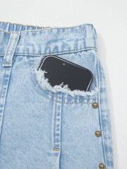 Light wash denim jeans with studded side detail and frayed pocket.