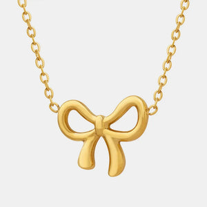 Delicate gold bow pendant necklace with a fine chain.