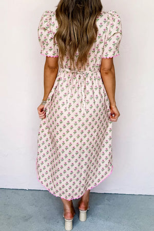 Floral V-neck midi dress in blush pink with scalloped trim and tie waist.