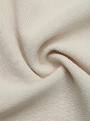 Beige tie-neck maternity overshirt fabric detail with subtle texture