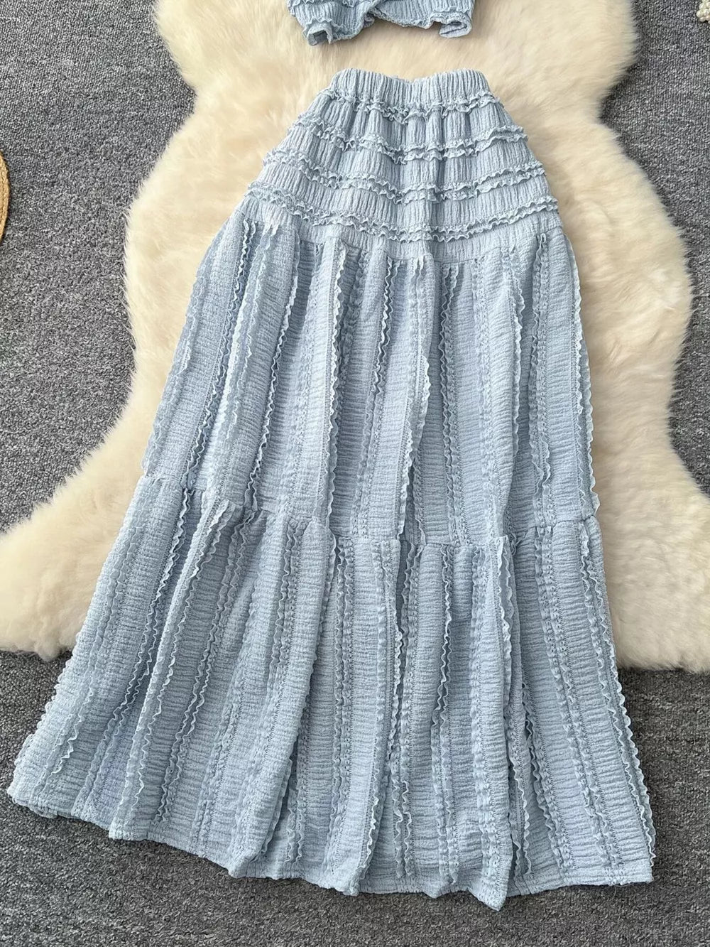 Light blue textured two-piece set with ruffled details and tiered skirt.