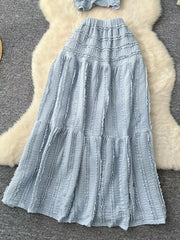 Light blue textured two-piece set with ruffled details and tiered skirt.
