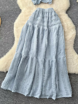 Light blue textured two-piece set with ruffled details and tiered skirt.
