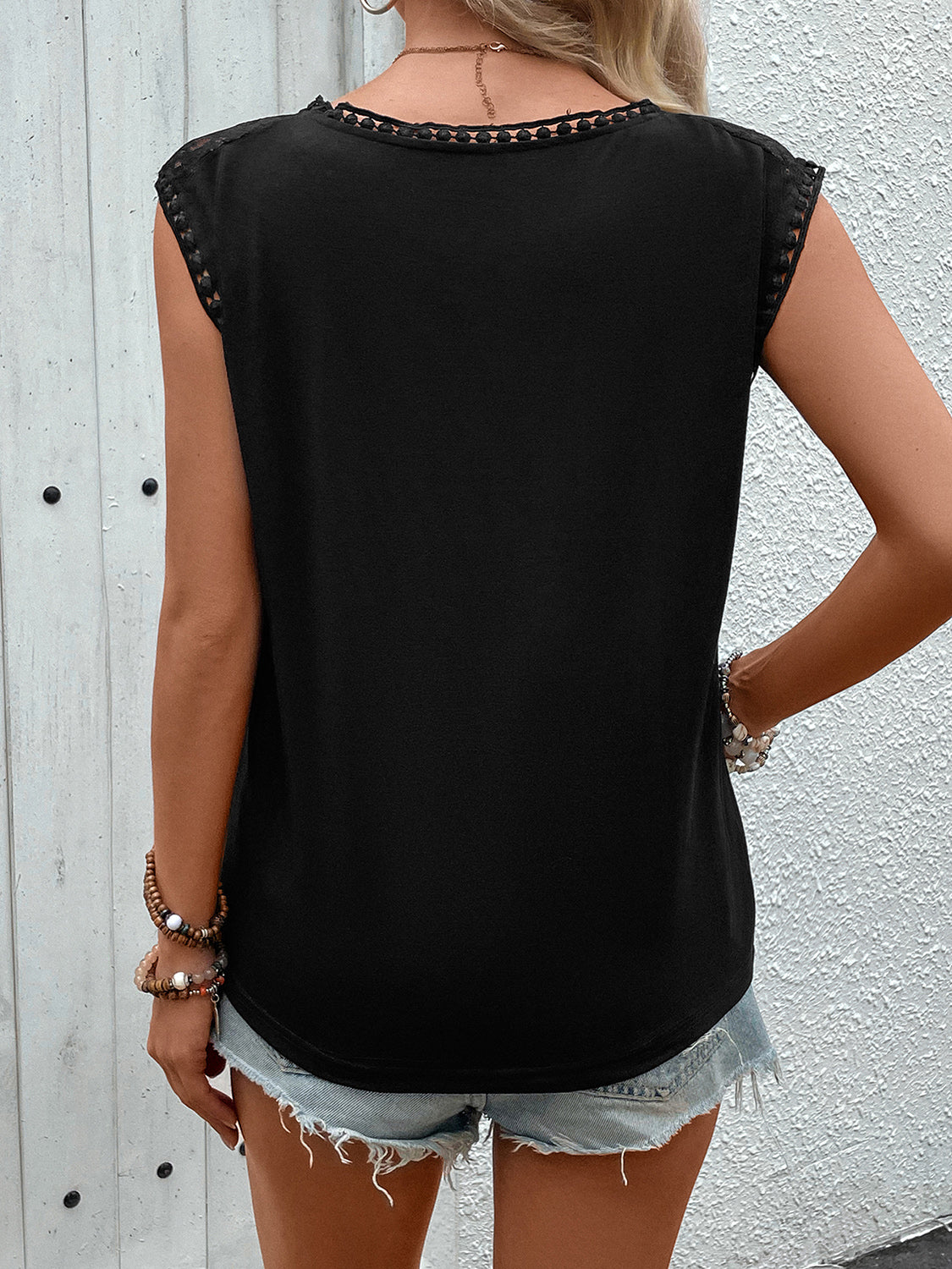 Black cap sleeve blouse with lace yoke and trim details