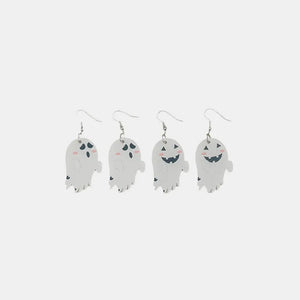 White acrylic dangle earrings with spooky ghost designs and happy faces.