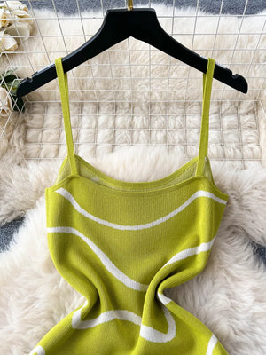 Green wavy knit midi dress with spaghetti straps and a bodycon fit.
