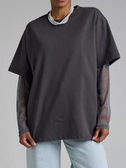 Oversized dark gray t-shirt with sheer sparkly long sleeves layered underneath.