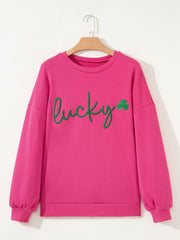 Pink crew neck sweatshirt with green embroidered lucky clover graphic