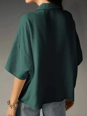 Dark green half sleeve shirt with a collared neckline, shown from the back.