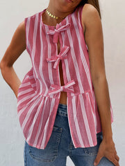 Fuchsia pink striped peplum top with bow tie closures and a ruffled hem.