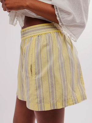 Pastel Yellow stripe shorts with elastic waistband and pocket detail.