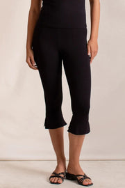 Black flared hem crop leggings with a subtle ruffle detail at the hem.