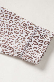 Leopard print pajama set with button-down detail and grey piping on cuff.