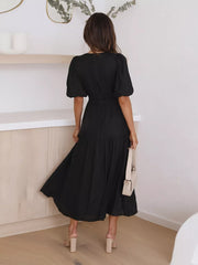 Black puff sleeve midi dress with tiered skirt and cinched waist.