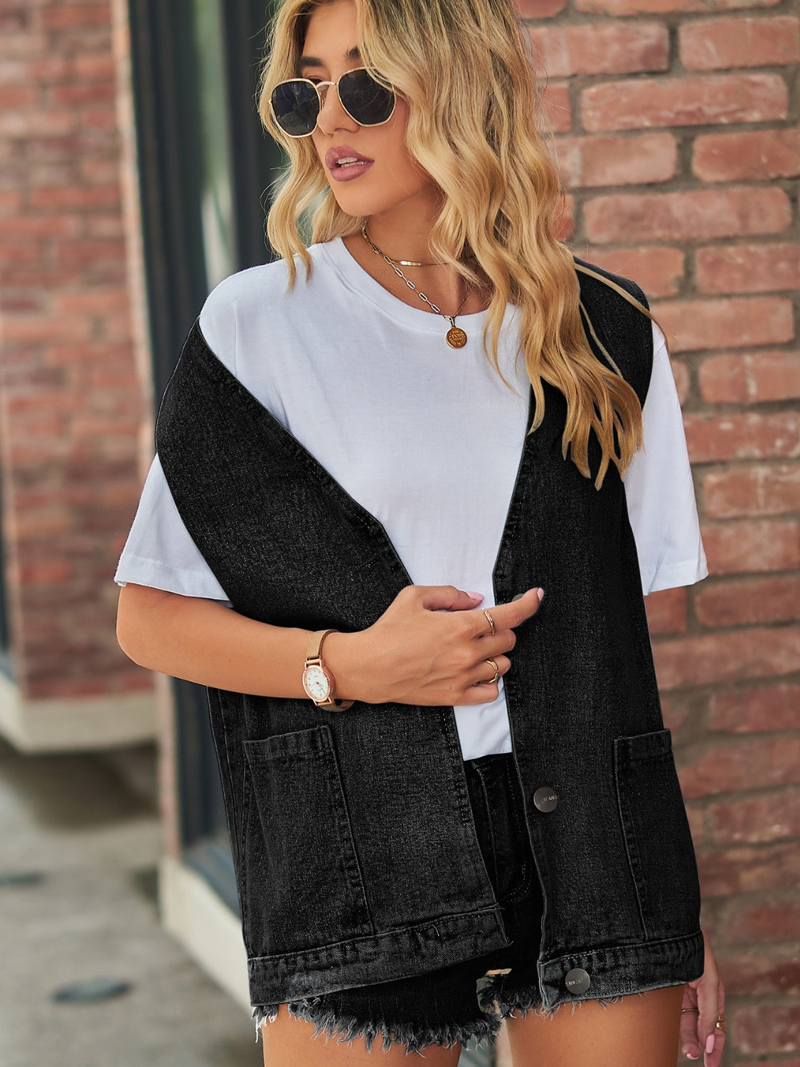Black oversized denim vest with patch pockets and button front.
