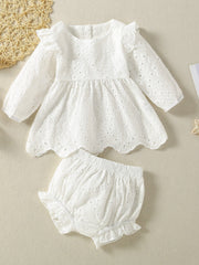 White cotton embroidered lace baby top with ruffled sleeves and scalloped hem, paired with bloomers.