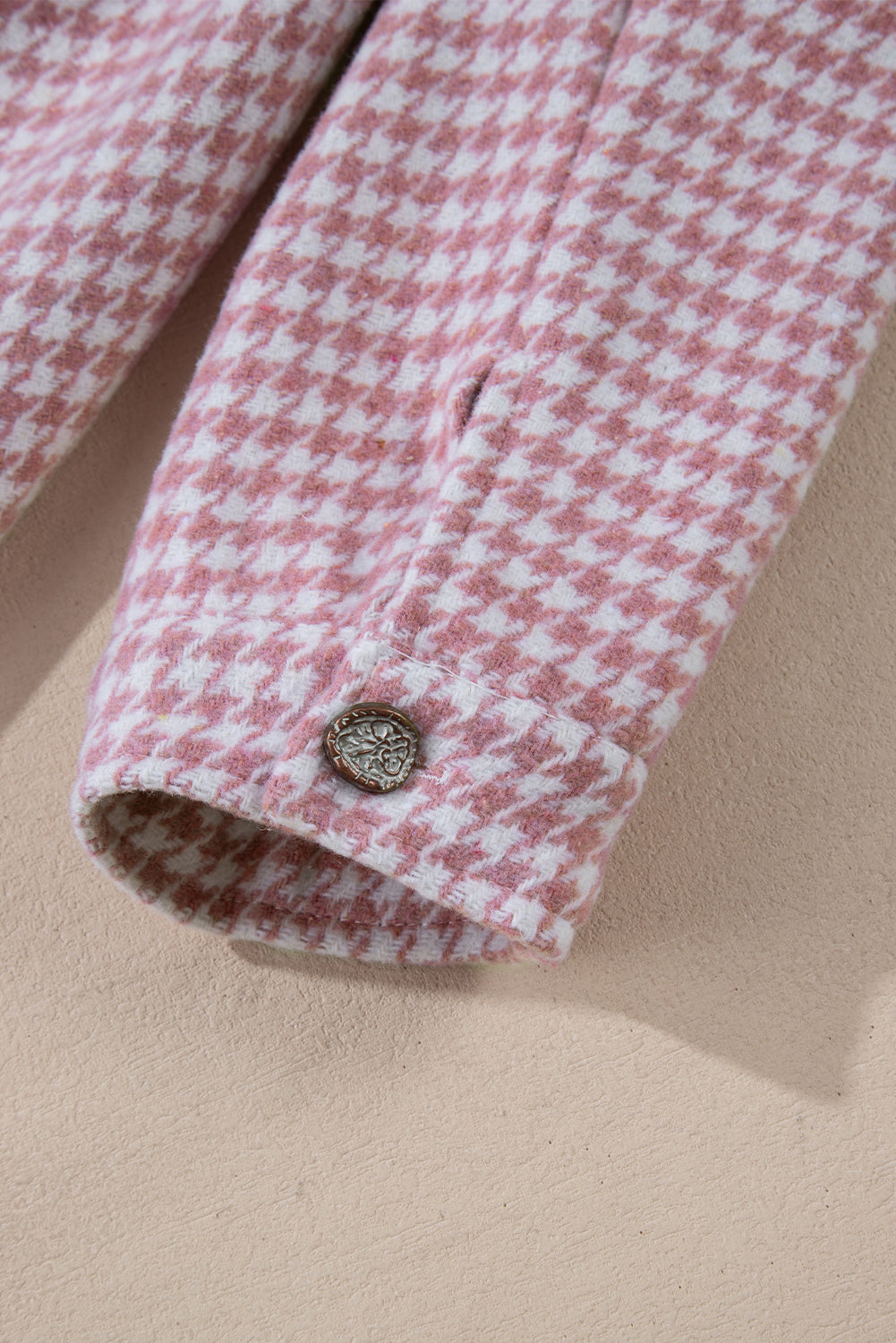 Dusty pink houndstooth shacket with a button cuff detail.