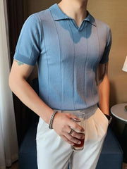 Dusty blue knit polo shirt with vertical ribbing and short sleeves.