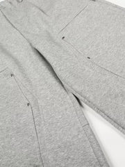 Gray men's sweatpants with wide legs and detailed pocket construction.