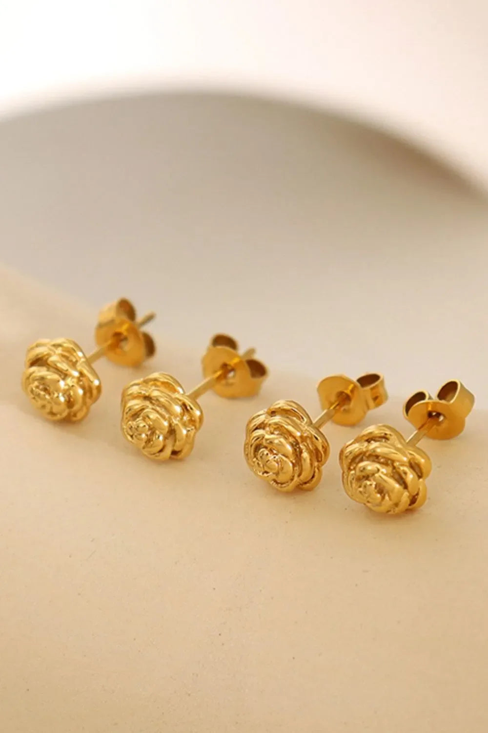 Gold rosebud stud earrings with 18K gold plating.