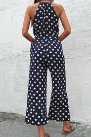 Navy polka dot halter neck palazzo jumpsuit with tie back detail