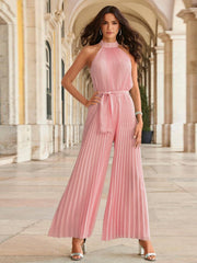 Blush pink pleated halter neck palazzo jumpsuit with self-tie belt.